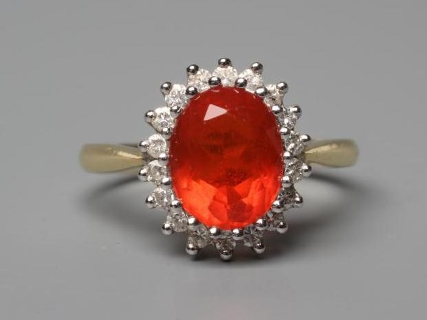 A FIRE OPAL AND DIAMOND CLUSTER RING Image
