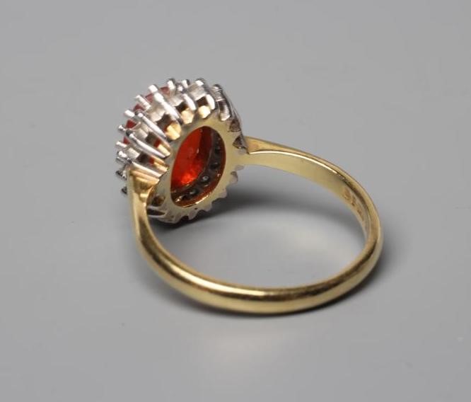 A FIRE OPAL AND DIAMOND CLUSTER RING Image