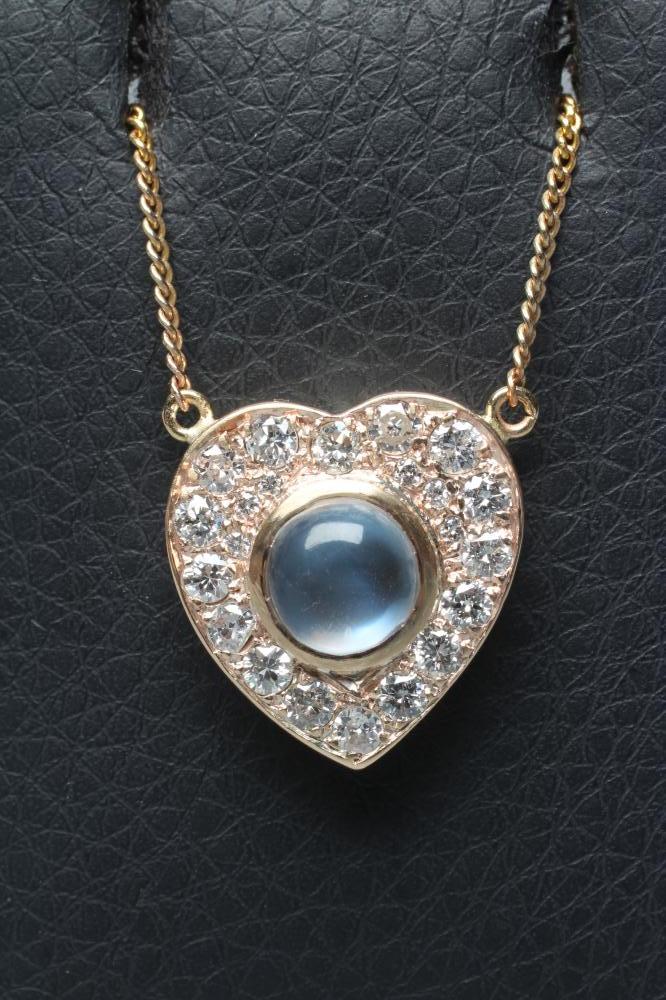 A MOONSTONE AND DIAMOND CLUSTER HEART PENDANT Image