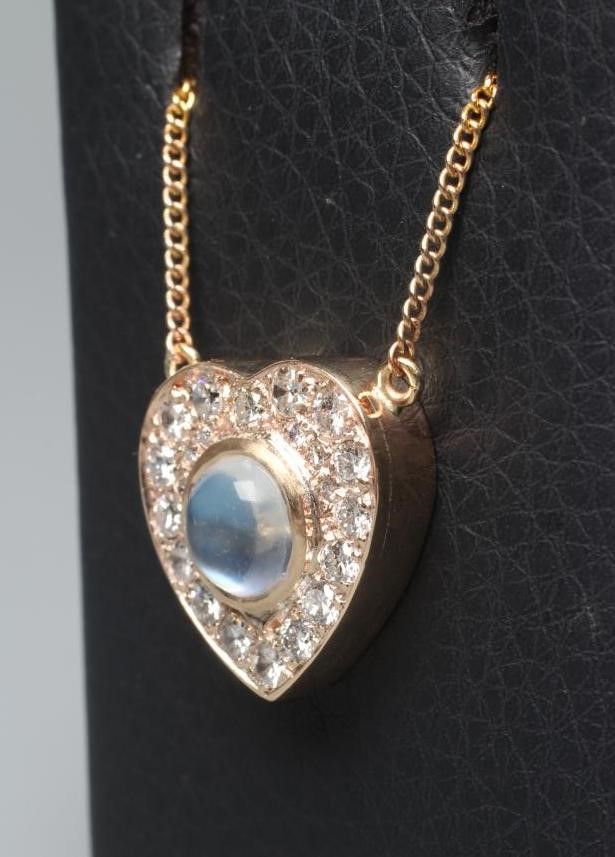 A MOONSTONE AND DIAMOND CLUSTER HEART PENDANT Image