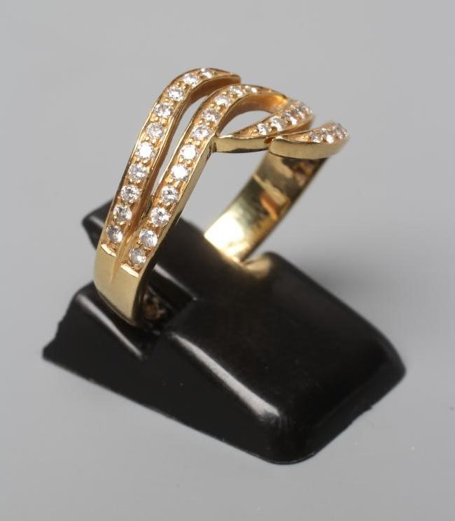 A DIAMOND HALF HOOP DRESS RING, the four scroll panels all point set with small stones to a plain Image