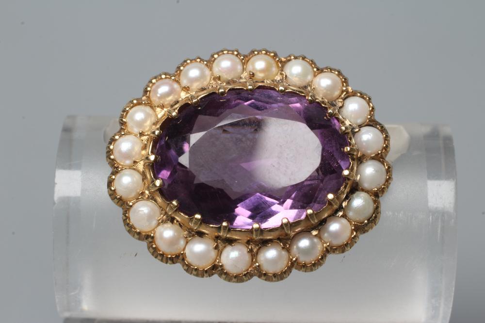 AN AMETHYST AND PEARL BROOCH, the oval facet cut amethyst claw set to a border of cultured pearls in Image
