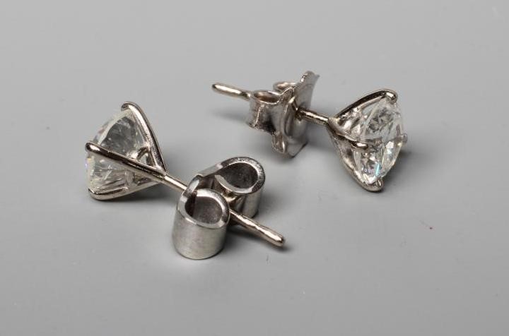A PAIR OF DIAMOND SOLITAIRE EAR STUDS Image