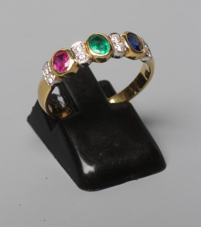 A MULTI GEM HALF HOOP RING collet set with an oval facet cut emerald Image