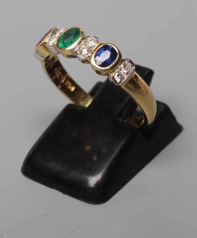 A MULTI GEM HALF HOOP RING collet set with an oval facet cut emerald Image