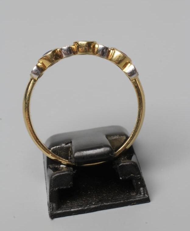 A MULTI GEM HALF HOOP RING collet set with an oval facet cut emerald Image