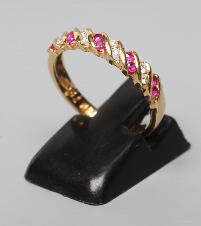 A RUBY AND DIAMOND HALF HOOP RING, channel set with alternating pairs of rubies and diamonds to a Image