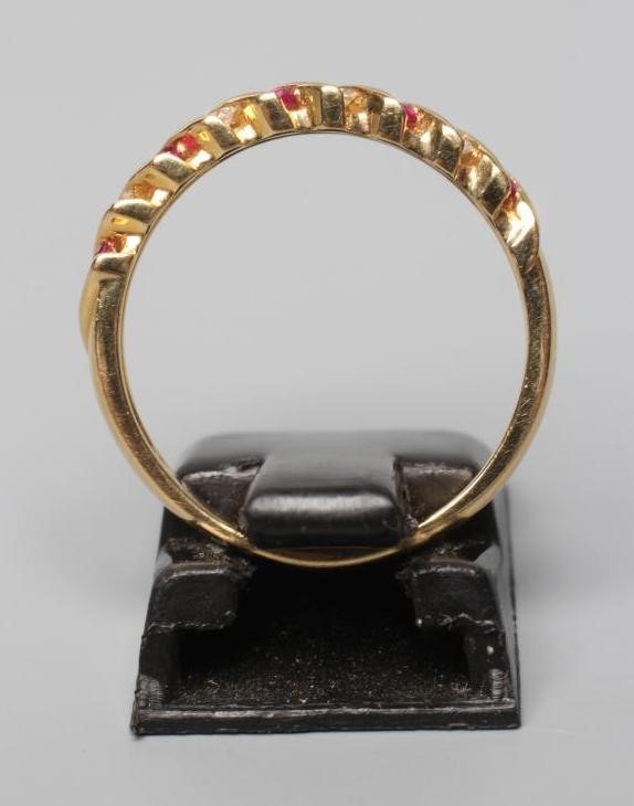 A RUBY AND DIAMOND HALF HOOP RING, channel set with alternating pairs of rubies and diamonds to a Image