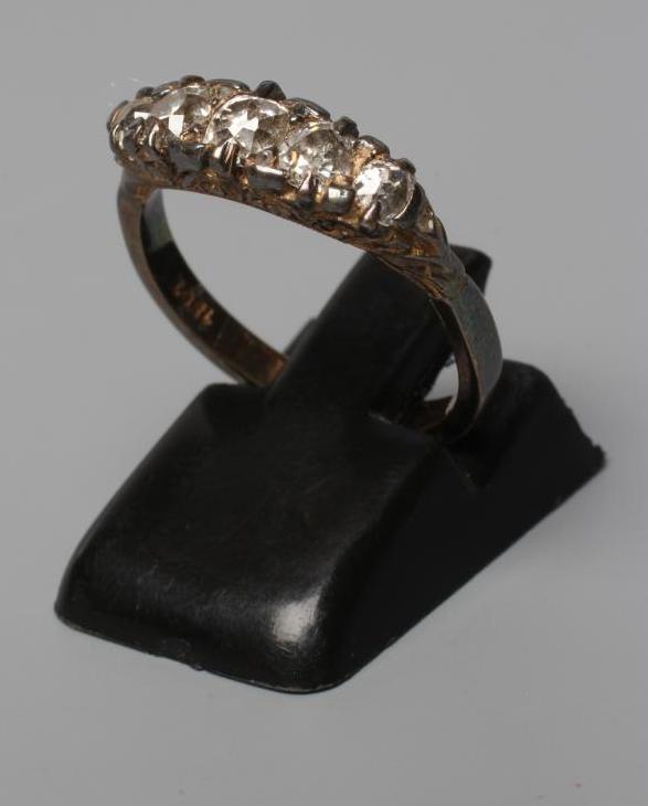 A FIVE STONE DIAMOND RING, the graduated mix cut stones point set to a plain shank stamped 18ct, Image