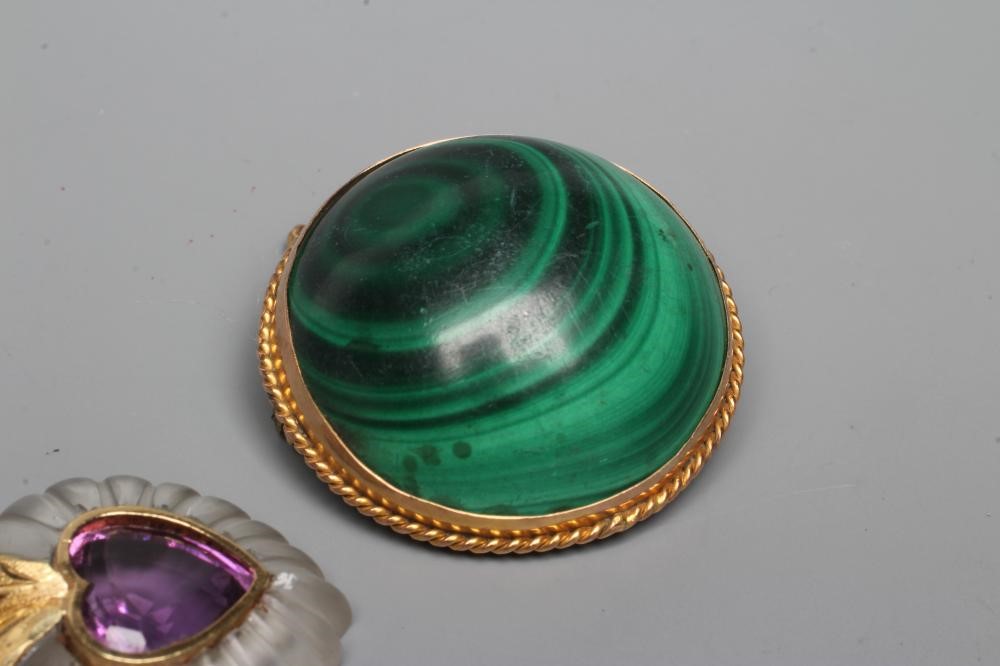 A HEART SHAPED PENDANT centred by an open back collet set facet cut amethyst with a fluted frosted Image