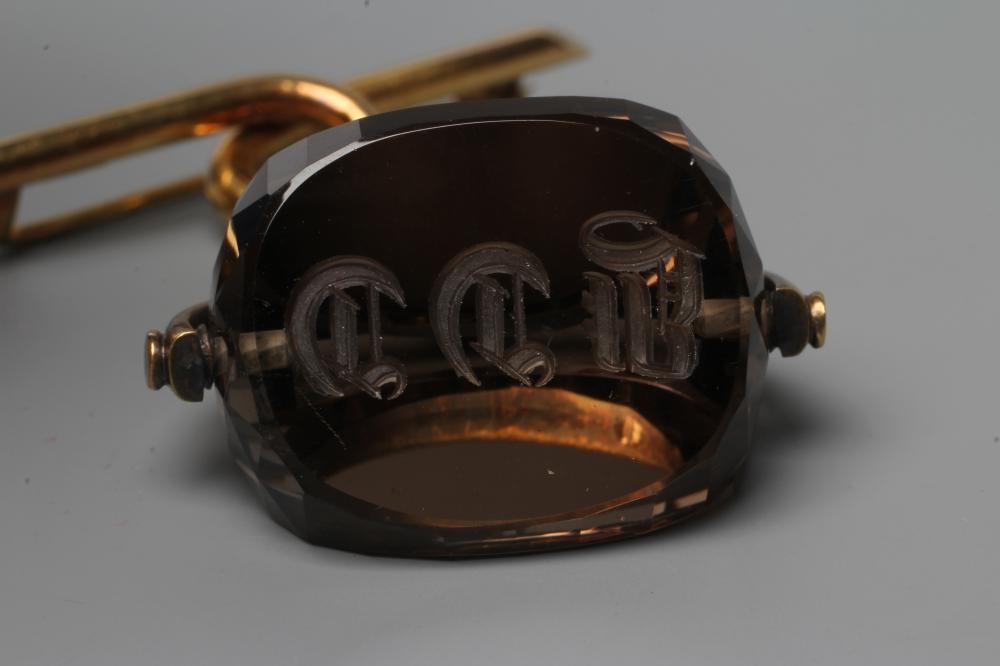 A LATE VICTORIAN SWIVEL FOB, the facet cut topaz(?) engraved with initials, on a plain mount, Image