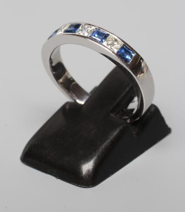 A SAPPHIRE AND DIAMOND HALF HOOP ETERNITY RING, the four sapphires and three princess cut diamonds Image