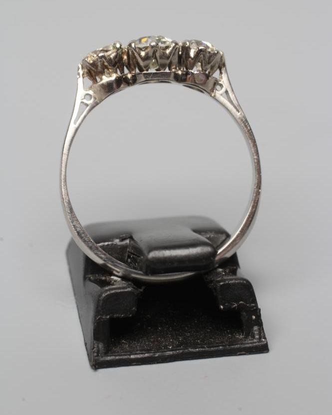 A THREE STONE DIAMOND RING, the old cut stones claw set and totalling approximately 0.8cts, to a Image
