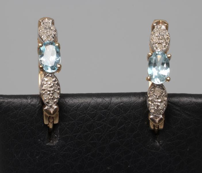 A PAIR OF BLUE TOPAZ AND DIAMOND HOOP EARRINGS, the oval topaz claw set between two panels of pave Image