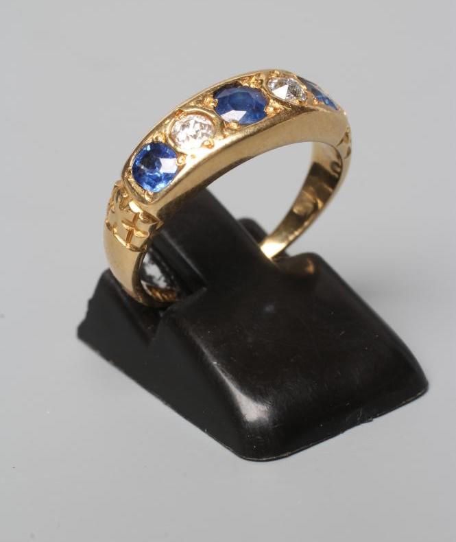 A LATE VICTORIAN SAPPHIRE AND DIAMOND HALF HOOP RING Image