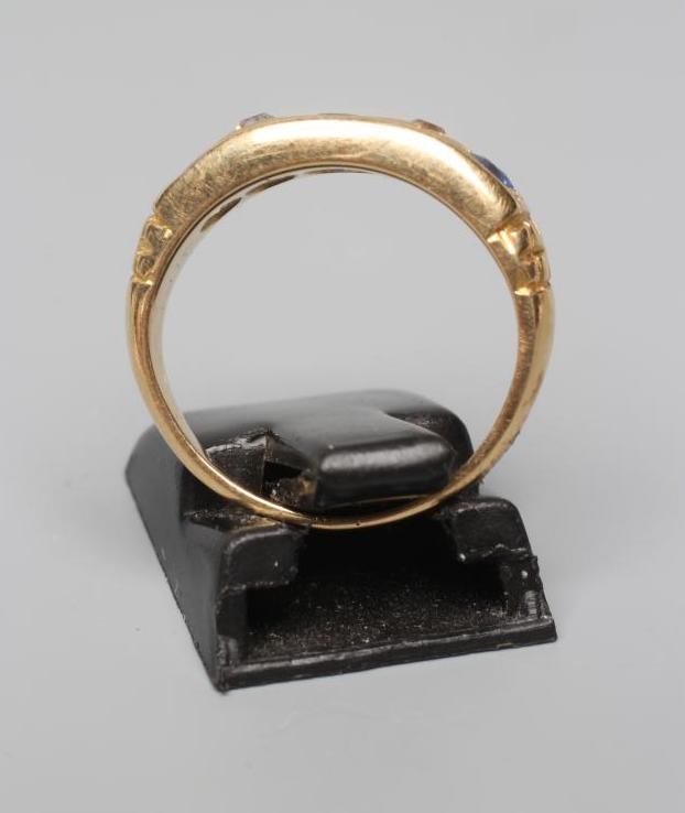 A LATE VICTORIAN SAPPHIRE AND DIAMOND HALF HOOP RING Image