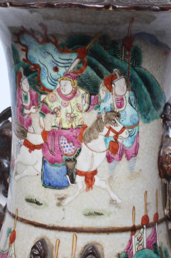 A CHINESE ALCOVE VASE of rouleau form with shi-shi handles and applied salamanders to the shoulders Image