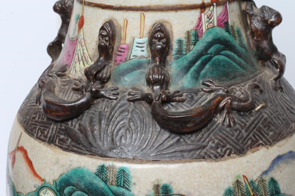 A CHINESE ALCOVE VASE of rouleau form with shi-shi handles and applied salamanders to the shoulders Image