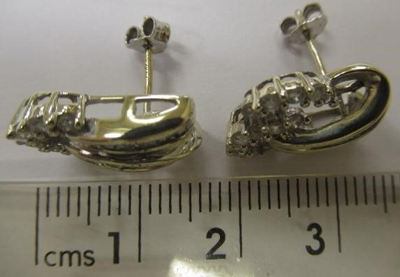 A PAIR OF DIAMOND STUD EARRINGS Image