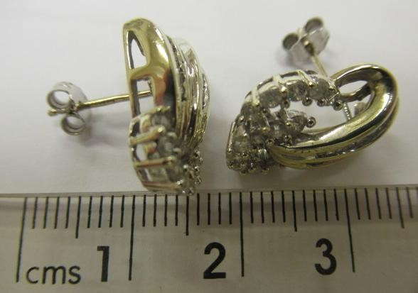 A PAIR OF DIAMOND STUD EARRINGS Image