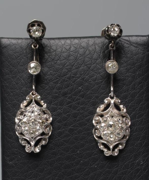 A PAIR OF DIAMOND DROP EARRINGS of open scroll quatrefoil form, pave with numerous stones, the screw Image