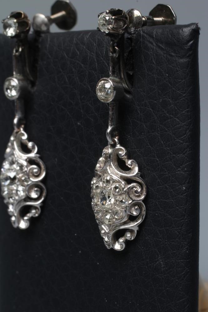 A PAIR OF DIAMOND DROP EARRINGS of open scroll quatrefoil form, pave with numerous stones, the screw Image