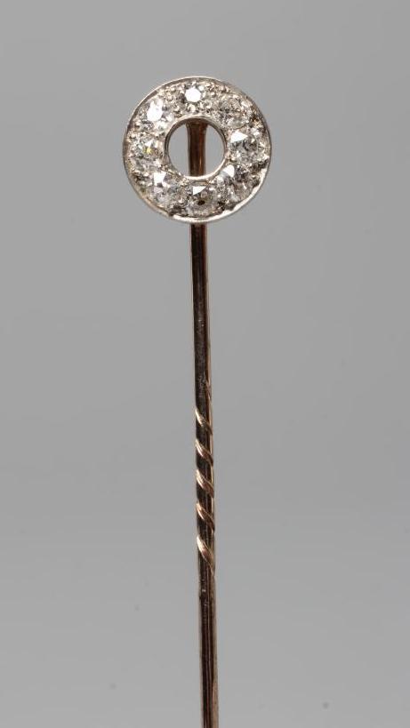 A DIAMOND STICK PIN, the "doughnut" finial pave set with eight old cut stones to a plain unmarked Image