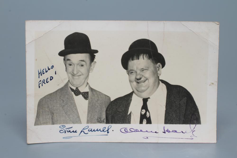 A SIGNED PHOTOGRAPH OF LAUREL AND HARDY inscribed "HELLO FRED", 5 1/2" wide (Est. plus 24% premium Image