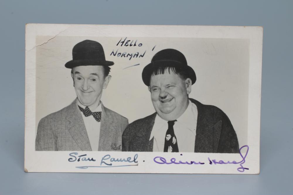 A SIGNED PHOTOGRAPH OF LAUREL AND HARDY inscribed "HELLO NORMAN", 5 1/2" wide (Est. plus 24% premium Image