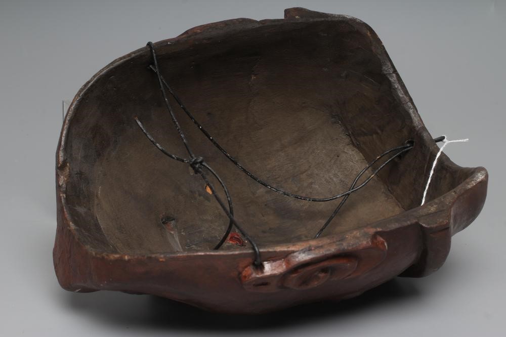 A JAPANESE CARVED WOOD NOH MASK painted in red, black and white, with holes for the eyes and Image