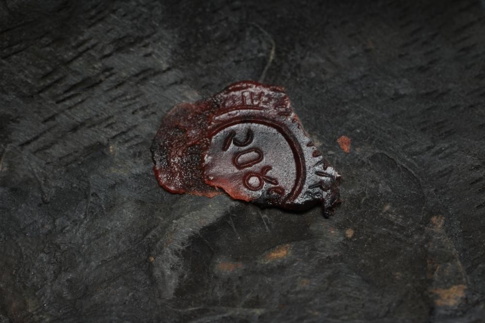 A JAPANESE CARVED WOOD NOH MASK painted in red, black and white, with holes for the eyes and Image