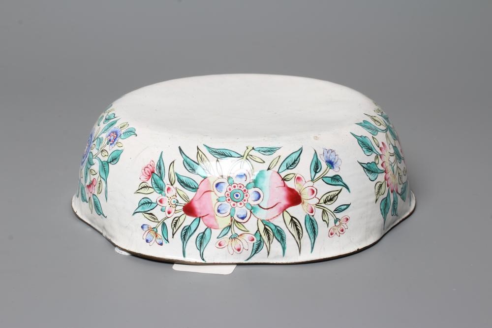 A CANTON ENAMEL BOWL of lobed circular form, painted in bright colours with dragons on a white Image