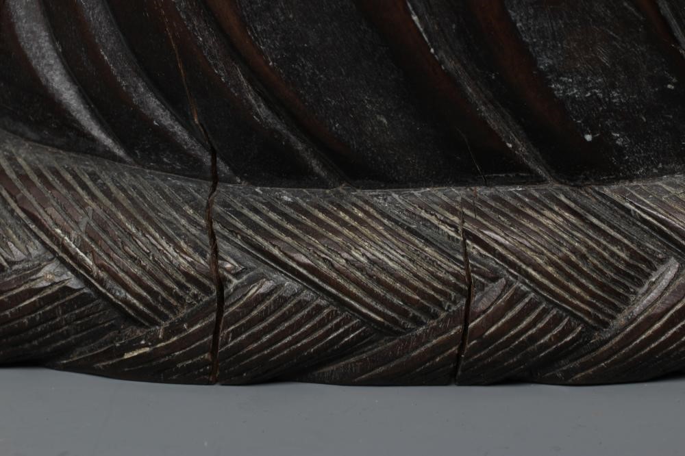 A CHINESE CARVED HARDWOOD BUDDAH, seated wearing a long bead necklace and with three children in Image