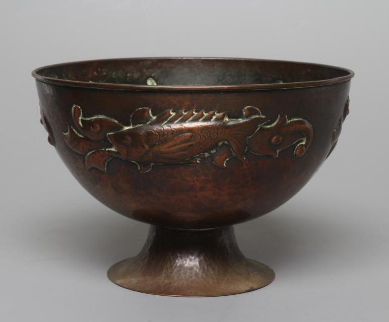 A NEWLYN COPPER PEDESTAL BOWL, early 20th century, hammered with a band of three scaly fish on a Image