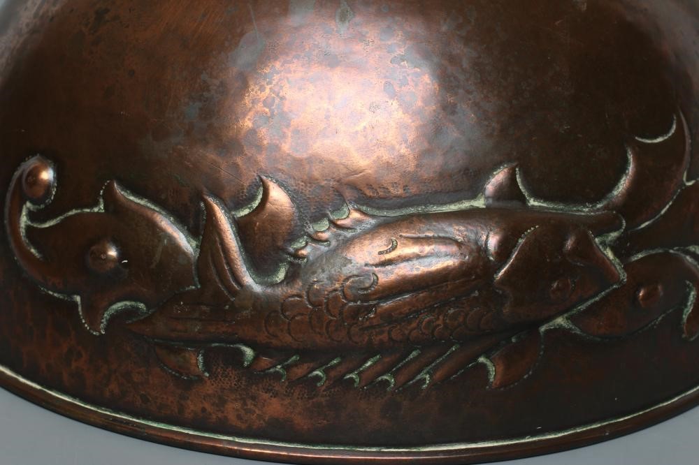 A NEWLYN COPPER PEDESTAL BOWL, early 20th century, hammered with a band of three scaly fish on a Image