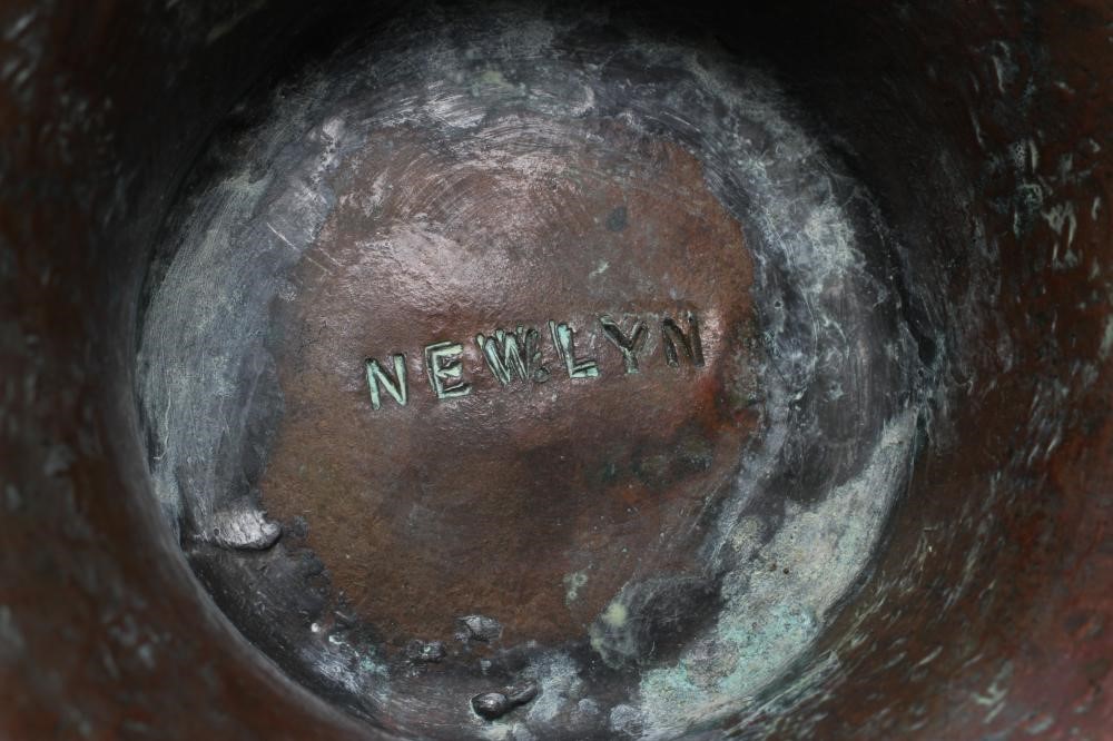 A NEWLYN COPPER PEDESTAL BOWL, early 20th century, hammered with a band of three scaly fish on a Image