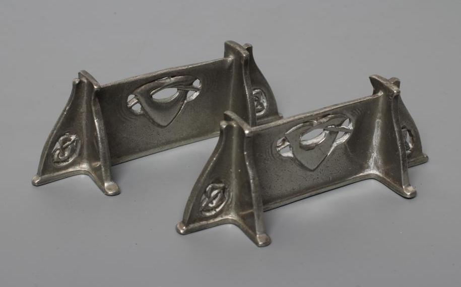 ARCHIBALD KNOX FOR LIBERTY - a pair of pewter knife rests, of oblong form and pierced with Image