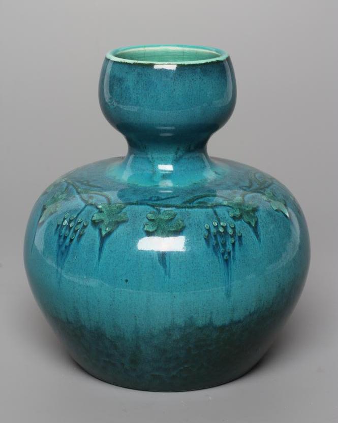 A RUSKIN VASE, early 20th century, of globular form with garlic type neck, the streaky blue souffle Image