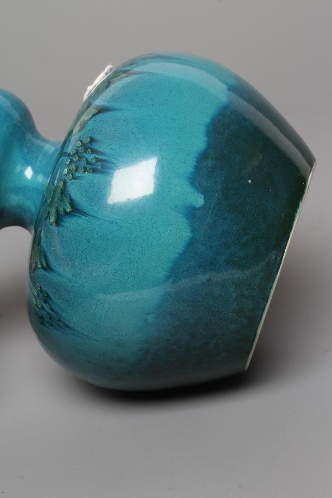 A RUSKIN VASE, early 20th century, of globular form with garlic type neck, the streaky blue souffle Image