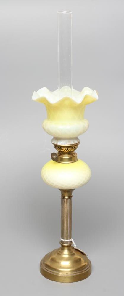 A SMALL VICTORIAN BRASS OIL LAMP, the yellow and white satin glass ball shaped shade and reservoir Image