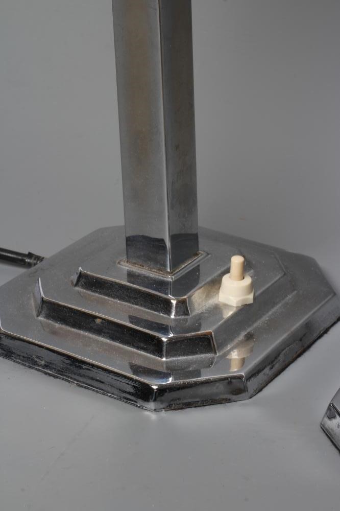 A PAIR OF ART DECO TABLE LAMPS, the stepped circular white glass shade on square chrome plated stem Image