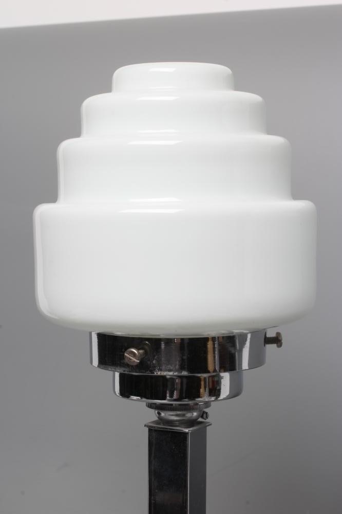 A PAIR OF ART DECO TABLE LAMPS, the stepped circular white glass shade on square chrome plated stem Image