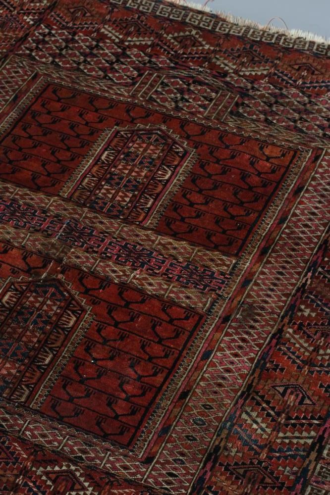 AN AFGHAN ENSI RUG, the field in two panels with candelabra motifs and central vertical elements, Image