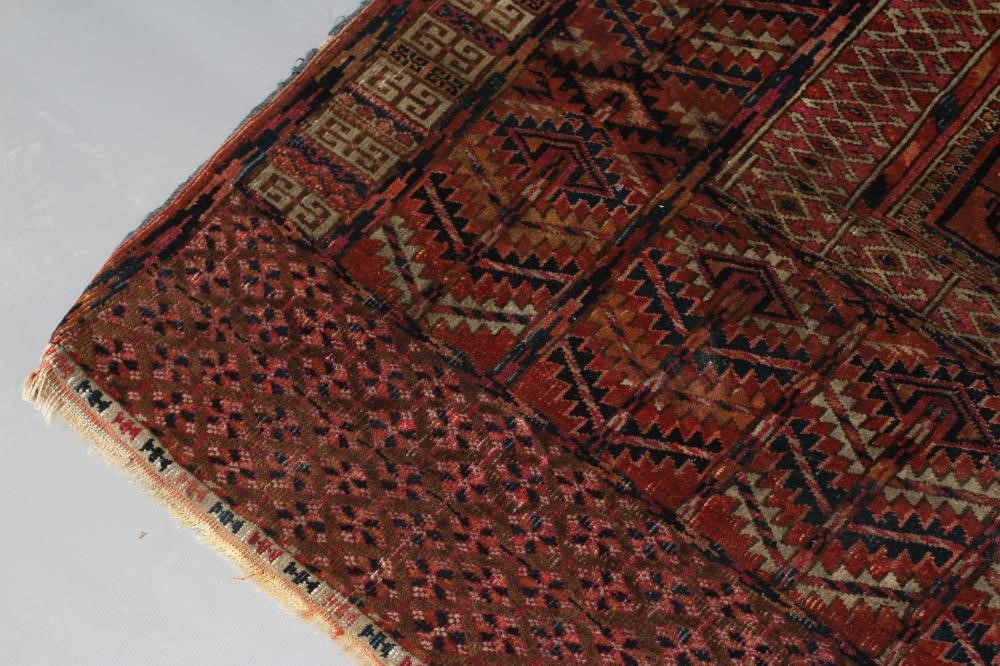 AN AFGHAN ENSI RUG, the field in two panels with candelabra motifs and central vertical elements, Image