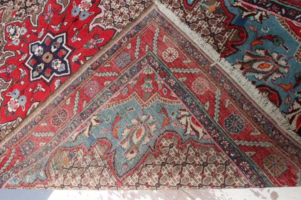 A PERSIAN RUG, the camel trellis patterned field with central crimson gul and pale blue spandrels, Image
