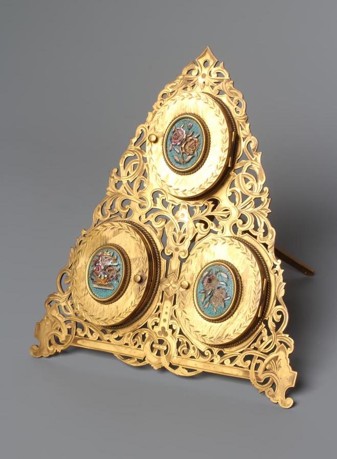 A LATE VICTORIAN GILT METAL TRIPLE PHOTOGRAPH FRAME of triangular section Image