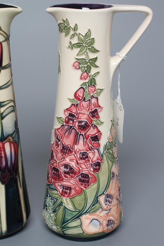 TWO MOORCROFT POTTERY PRETTY PENNY AND FOXGLOVE EWERS of tapering cylindrical form Image