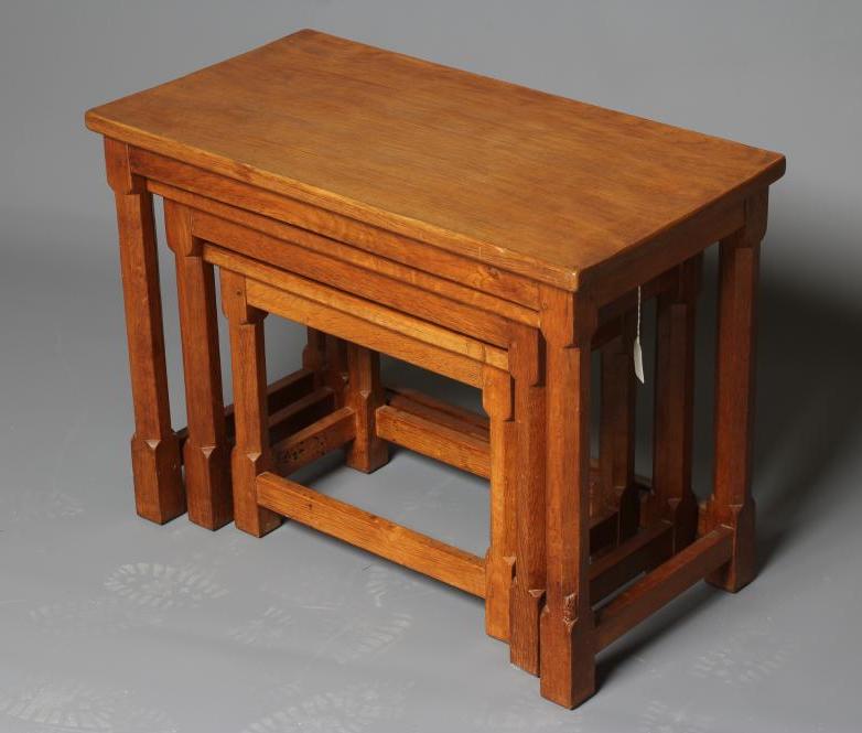 A WILFRED HUTCHINSON (HUSTWAITE) NEST OF THREE ADZED OAK TABLES Image