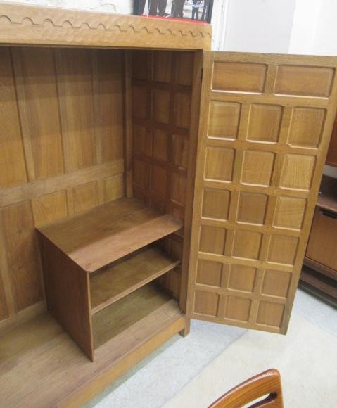 A ROBERT THOMPSON ADZED OAK WARDROBE of oblong multi panelled form with half penny moulded cornice Image