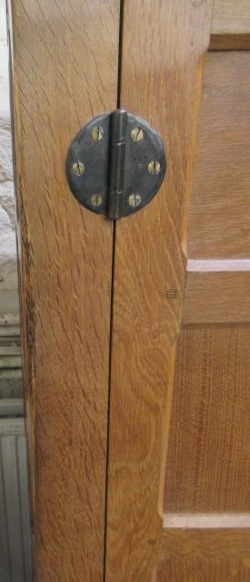 A ROBERT THOMPSON ADZED OAK WARDROBE of oblong multi panelled form with half penny moulded cornice Image